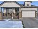 House exterior showcasing a front porch and attached garage at 592 Bristolwood Ln, Castle Pines, CO 80108