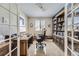 Home office with built-in shelving and a large desk at 592 Bristolwood Ln, Castle Pines, CO 80108