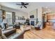 Spacious living room with hardwood floors, fireplace, and ample natural light at 592 Bristolwood Ln, Castle Pines, CO 80108