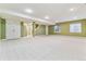 Spacious finished basement with neutral carpet, recessed lighting, and two egress windows providing natural light at 2330 S Salem Cir, Aurora, CO 80014