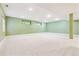 Large finished basement with neutral carpet, recessed lighting, and egress windows bringing in natural light at 2330 S Salem Cir, Aurora, CO 80014