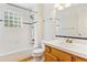Bathroom features tiled shower and tub combination with updated vanity and ample lighting at 2330 S Salem Cir, Aurora, CO 80014