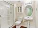 Bathroom featuring a glass enclosed shower, decorative lighting, pedestal sink and updated toilet at 2330 S Salem Cir, Aurora, CO 80014