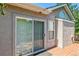 Exterior view of the home showing the deck, stucco, window and sliding glass door at 2330 S Salem Cir, Aurora, CO 80014