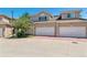 Townhome featuring a two-car garage, stucco exterior, and well maintained driveway and landscaping at 2330 S Salem Cir, Aurora, CO 80014