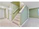 Hallway featuring plush carpet on the stairs, updated doors, and neutral wall color at 2330 S Salem Cir, Aurora, CO 80014
