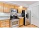 Well-maintained kitchen featuring modern stainless steel appliances and wooden cabinetry at 2330 S Salem Cir, Aurora, CO 80014