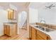 Kitchen featuring a stainless steel double sink, cabinetry, tile countertops, and view to staircase at 2330 S Salem Cir, Aurora, CO 80014