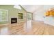 Spacious living room with hardwood floors, a fireplace, vaulted ceilings, and access to outdoor patio at 2330 S Salem Cir, Aurora, CO 80014