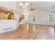 Open-concept living room with hardwood floors, a staircase, and a breakfast bar overlooking the kitchen at 2330 S Salem Cir, Aurora, CO 80014