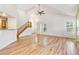 Open-concept living room with vaulted ceilings, hardwood floors, and a staircase leading to the second level at 2330 S Salem Cir, Aurora, CO 80014