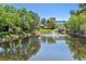 Scenic community pond with a fountain, lush greenery, and building backdrop at 2330 S Salem Cir, Aurora, CO 80014