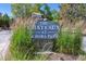 Community sign for The Chateaux at Aurora Park, surrounded by plants at 2330 S Salem Cir, Aurora, CO 80014