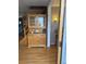 Entryway view of hardwood floors and a quaint hutch by the stairway at 3901 S Washington St, Englewood, CO 80113