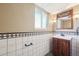 Bathroom featuring single sink vanity with dark wood cabinets and decorative mirror at 4080 E Caley Cir, Centennial, CO 80121