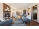 Spacious living room featuring hardwood floors, a fireplace, and access to other areas of the home at 4080 E Caley Cir, Centennial, CO 80121