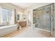 This bathroom showcases a soaking tub, a glass-enclosed shower, and a double sink vanity for a spa-like experience at 6980 S Yantley Ct, Aurora, CO 80016