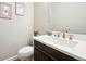 Powder room featuring a white vanity top, vessel sink, bronze plumbing fixtures, and a comfort height toilet at 6980 S Yantley Ct, Aurora, CO 80016