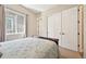 Well-lit bedroom featuring a comfortable bed, neutral walls, and a double closet at 6980 S Yantley Ct, Aurora, CO 80016