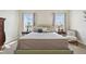 This bedroom features dual windows, a padded headboard, and stylish decor that create a calm, inviting space at 6980 S Yantley Ct, Aurora, CO 80016
