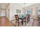 Elegant dining room with a chandelier, a large window, and views of the front entry at 6980 S Yantley Ct, Aurora, CO 80016