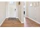 Bright foyer featuring hardwood floors and a glimpse into the home's spacious layout at 6980 S Yantley Ct, Aurora, CO 80016