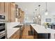 The kitchen features a large island, stainless appliances, and an adjacent dining area at 6980 S Yantley Ct, Aurora, CO 80016