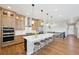 Gourmet kitchen boasts a large island with seating and stainless steel appliances at 6980 S Yantley Ct, Aurora, CO 80016