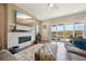 Cozy living room featuring a fireplace, a large TV, and access to the outdoor patio at 6980 S Yantley Ct, Aurora, CO 80016