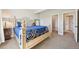 Elegant main bedroom with a decorative bed frame and a view of a walk-in closet at 6980 S Yantley Ct, Aurora, CO 80016