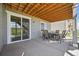 Covered patio with an outdoor dining area and sliding glass doors leading to the interior at 6980 S Yantley Ct, Aurora, CO 80016