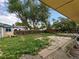 Spacious backyard with a patio, bordered by a wooden fence and mature trees at 7409 Pierce St, Arvada, CO 80003