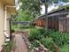 Landscaped backyard featuring a brick walkway, garden beds, and wooden fence, offering a serene outdoor space at 7409 Pierce St, Arvada, CO 80003