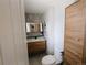 Modern bathroom with wood vanity, storage, and stylish wall accents at 7409 Pierce St, Arvada, CO 80003