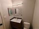 Modern bathroom features a wood vanity, framed mirrors, and tile backsplash for an elegant and functional design at 7409 Pierce St, Arvada, CO 80003