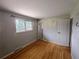 Sunlit bedroom with wood floors, a neutral palette, and a large window offers a bright and airy space at 7409 Pierce St, Arvada, CO 80003