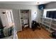 Spacious bedroom features hardwood floors, built-in bookshelves, and a closet for ample storage and organization at 7409 Pierce St, Arvada, CO 80003