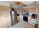 Functional kitchen with white appliances, light wood cabinets, and white countertops at 7409 Pierce St, Arvada, CO 80003