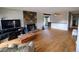 Open-concept living room with hardwood floors, stone fireplace, and an open floor plan at 7409 Pierce St, Arvada, CO 80003