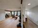 Spacious living room featuring hardwood floors, brick fireplace, and a desk area at 7409 Pierce St, Arvada, CO 80003