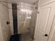 Modern bathroom features a sliding glass door shower with gray and dark decorative tile and bronze fixtures at 7409 Pierce St, Arvada, CO 80003