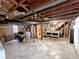 Unfinished basement with exposed ceiling, laundry hookups, and ample space offers potential for customization and expansion at 7409 Pierce St, Arvada, CO 80003