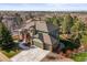 An aerial view of a lovely two-story home, a three-car garage and a scenic neighborhood at 10831 Eagle Crest Ln, Parker, CO 80138