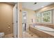 View of bathroom with soaking tub, tile floors, and a door to an adjoining bedroom at 10831 Eagle Crest Ln, Parker, CO 80138