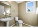 Powder room with pedestal sink and natural lighting at 10831 Eagle Crest Ln, Parker, CO 80138