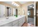 Bright bathroom featuring double sinks, a large mirror, and a separate shower area at 10831 Eagle Crest Ln, Parker, CO 80138