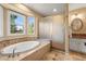 Bathroom with a soaking tub next to a window and a glass enclosed shower at 10831 Eagle Crest Ln, Parker, CO 80138