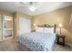 Bedroom with a ceiling fan, a queen bed, and a door to an en suite bathroom at 10831 Eagle Crest Ln, Parker, CO 80138