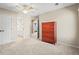 Empty bedroom with a dresser and doors to a closet and an en suite bathroom at 10831 Eagle Crest Ln, Parker, CO 80138