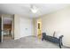 Bedroom with a gray upholstered bench and doors to a closet and an en suite bathroom at 10831 Eagle Crest Ln, Parker, CO 80138